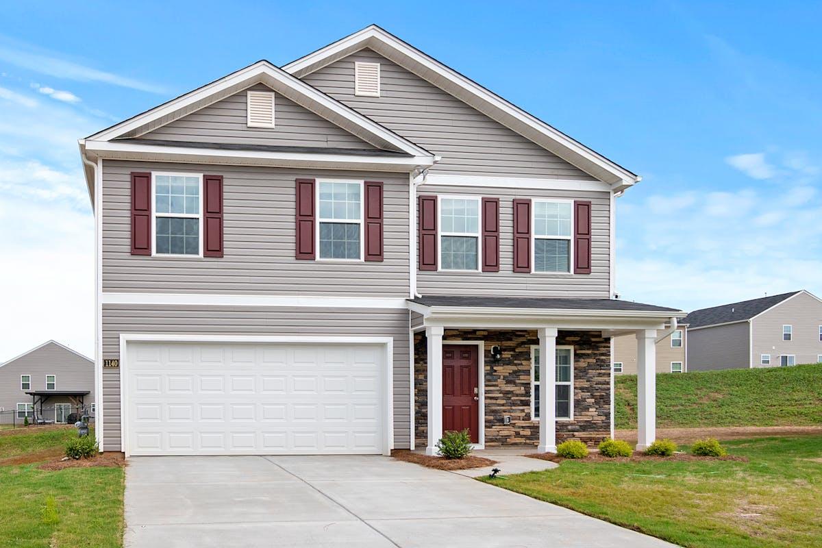 Modern grey vinyl siding home with stone accent